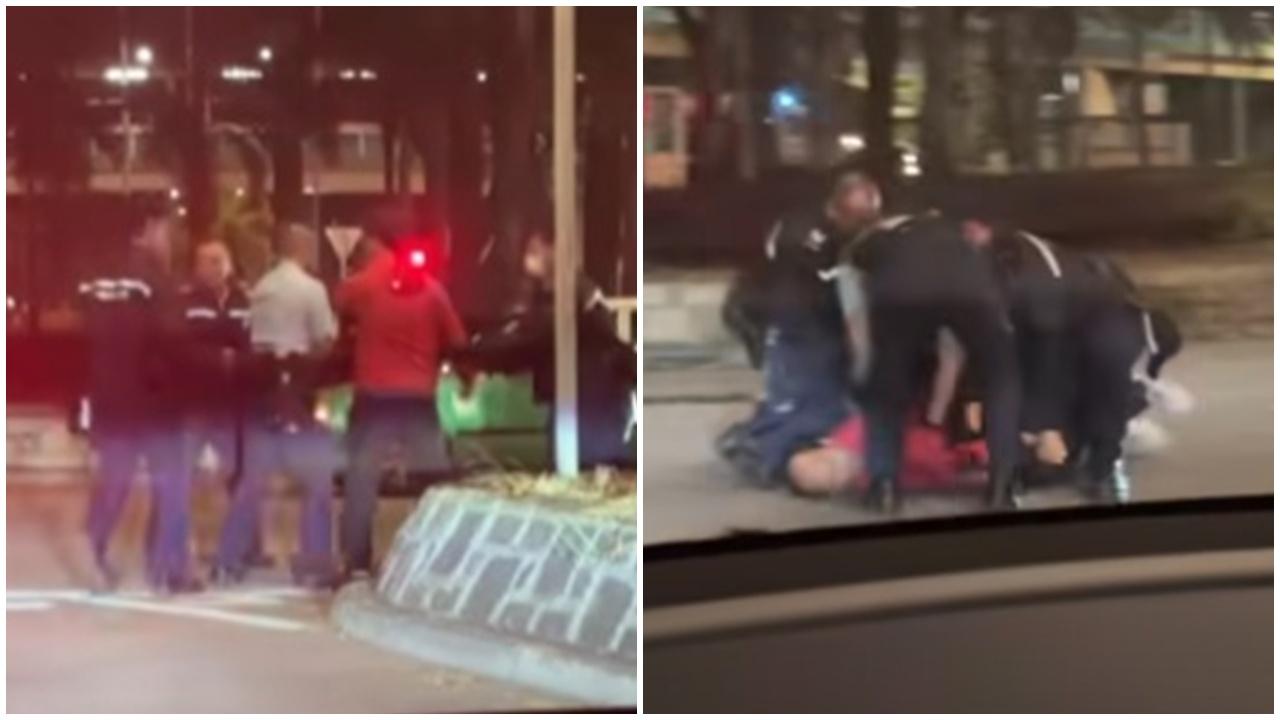 粉嶺中年漢闖馬路揮舞鐵板，多名警員合力制服。(FB/車cam L (香港群組))