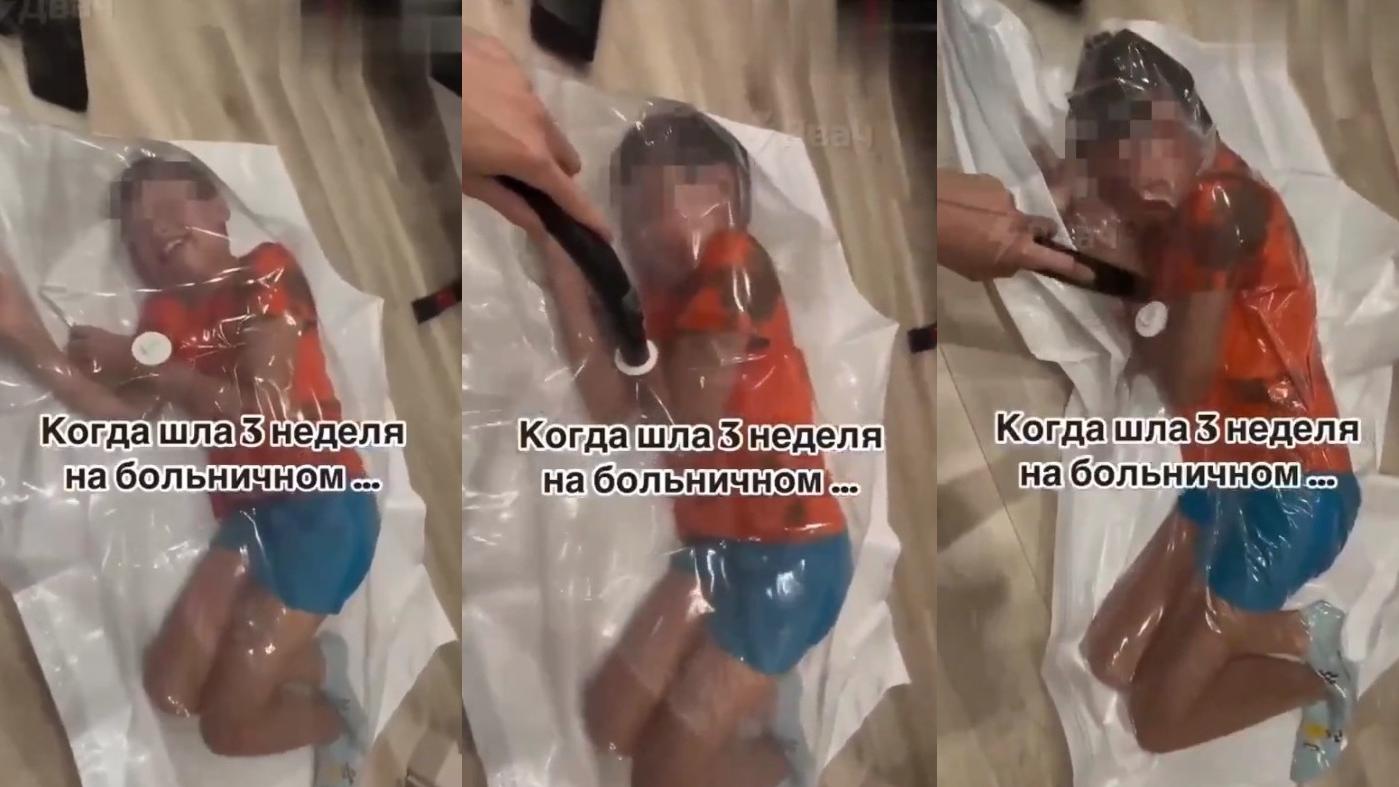 男童被媽媽裝入大膠袋抽真空，看來受驚。(互聯網)